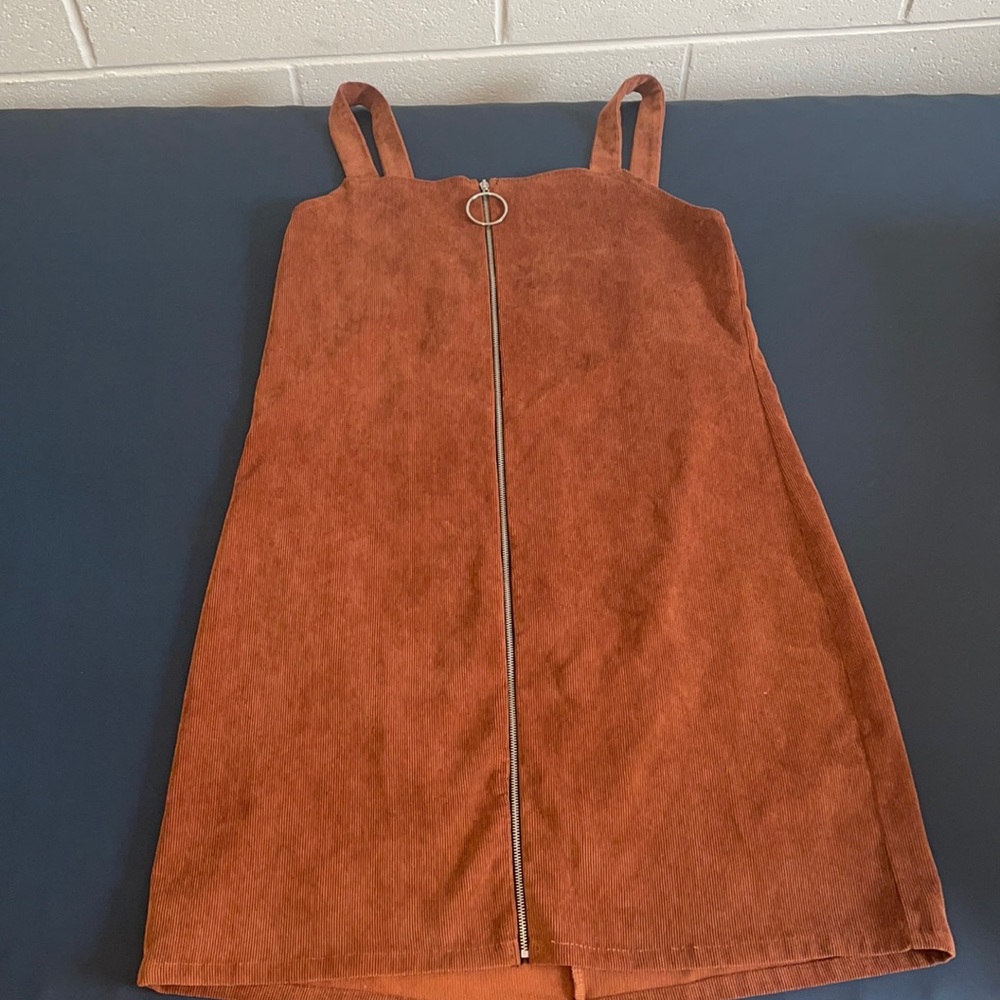 Popular Basics size L. It is a straight fit dress, but it hugs curves perfectly.